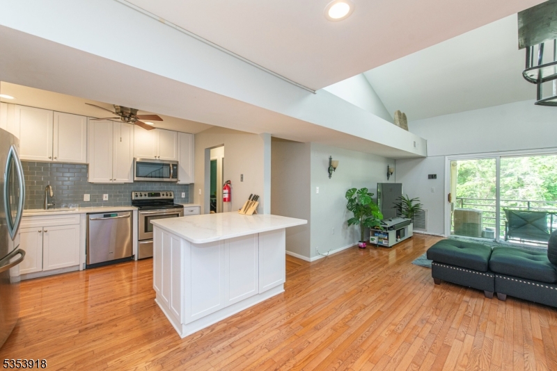 Welcome Home! Discover the perfect blend of convenience and comfort in this stunning top-floor condo featuring a spacious loft and an additional room ideal for a home office. With 3 generously sized bedrooms and 2 full baths, this beautifully updated unit offers an elevated lifestyle in one of Morristown's most desirable buildings. This home features a renovated kitchen with quartz countertops, updated cabinets, stainless steel appliances, and a large island with bonus storage, perfect for everyday living and entertaining. The bathrooms have been thoughtfully modernized, while the gleaming hardwood floors flow throughout the open concept layout. Enjoy the comfort of central air and the convenience of in-unit laundry, in addition to natural gas and public utilities. The expansive primary suite features a walk-in closet and luxurious en-suite bath. Remote-controlled, solar-powered skylights flood the space with natural light, adding to the airy ambiance of the lofted ceilings. Unwind on your private balcony with serene park views, offering rare privacy and a peaceful backdrop. Amenities include an elevator, gym and additional private storage. Best of all, this exceptional unit is just a short walk from Morristown Green, the train station, top-rated restaurants, shops, and entertainment venues. With easy access to major highways, your commute and weekend getaways are a breeze. Don't miss this opportunity to own a truly unique, move-in-ready home in the heart of Morristown!