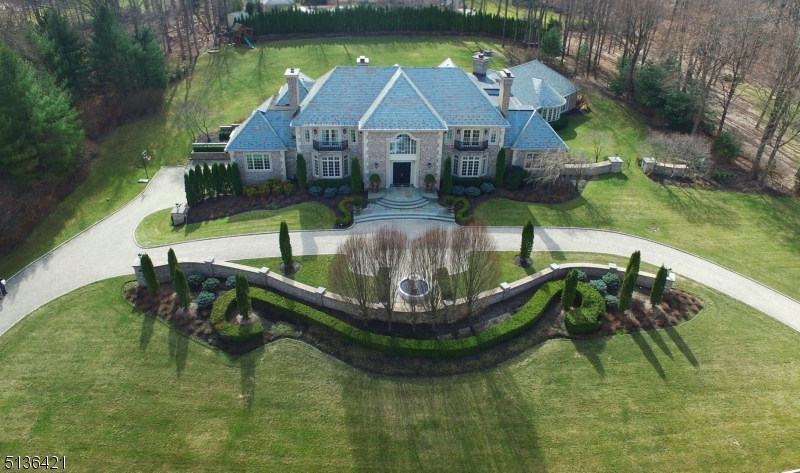 Luxury Built Brick Estate Home with a Slate Roof & Set on 2 Acres. Hand carved mahogany doors. 2-story marble foyer with dual bridal staircase. Warm & inviting living room & elegant dining room, both with fireplaces. Magnificent great room, fireplace & built-in cabinetry & wall of windows overlooking the grounds. Uniquely designed bar room with a wet bar with access to patio and perfect for indoor & outdoor entertaining. Office on the 1st floor with fireplace. Upscale kitchen with top-of-the-line appliances is one-of-a-kind & perfect for a chef. Adjoining the kitchen is a very light & bright breakfast room with fireplace. In a separate wing there is a spectacular indoor pool & spa with fireplace for year round entertaining & has multiple French doors opening to the patio. Beautifully appointed primary suite with fireplace, private staircase, custom closets & lavish bath. Lower level has media room, family rm, gym & bath. 5 car garage. Rio Vista amenities:pool/tennis/gym/clubhouse.