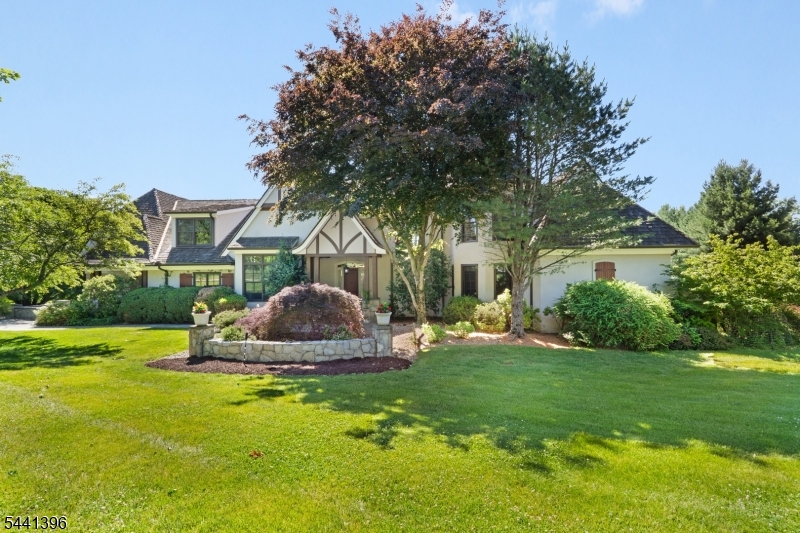 Spectacular views abound from this captivating French Normandy design Custom Home replete with earth-tone hard coat stucco exterior, steeply pitched roofline, cedar shake roof, & boasting the coveted benefit of one-floor living with luxurious first floor primary bedroom suite- a truly unique & architecturally dynamic home that blends striking design, dramatic proportion, in the most compelling of ways - expertly maintained and move-in ready.  Prized commuter-friendly east Mendham Township location on a quiet cul-de-sac street with mesmerizing rear yard views of the panoramic landscape. Enjoy a commodious, easy-living floor plan comprising 8 rooms including 3 airy bedrooms (each with en suite full bath access), powder room, gorgeous great room with access to a stunning veranda, flawless designer kitchen with roomy eat-in dinging area, well-appointed butler's pantry, tasteful formal dining room, resplendent sunroom, superb cloistered primary bedroom suite, handsome home office, expansive unfinished bonus room area over the garage presenting tremendous future potential- this unique home spans 4,516 sq ft on the upper 2 floors alone, plus the added utility of a sprawling unfinished basement level with walk-out, paved driveway leading to a spacious parking area with 3 car garage, jaw-dropping circular veranda extending out to a delightful bluestone patio, professionally designed & maintained 2-acre showcase property. Whole-house natural gas back-up generator.
