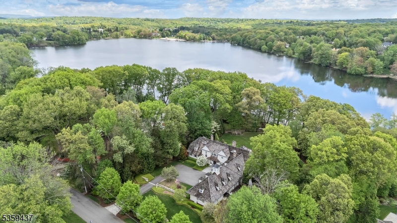 Experience elegance and comfort in this stunning 7,823 square foot custom-built estate, perfectly positioned on two acres of lakefront property. Offering incredible lake views and an expansive layout designed for both grand entertaining and everyday living this property is not to be missed.Relax in the expansive open-concept living room or bask in natural light from the stunning sunroom. Additional spaces include an inviting family room, a playroom, an intimate den plus a grand bonus room?perfectly suited for a private gym, game room, or personalized retreat.This home also boasts a fully appointed first floor suite offering ample space for visiting guests.Outside, relax or entertain in style beside the beautiful in-ground pool, all set against the serene backdrop of lake views. This extraordinary home offers a unique opportunity to own a private lakefront retreat with room to grow, gather and enjoy.