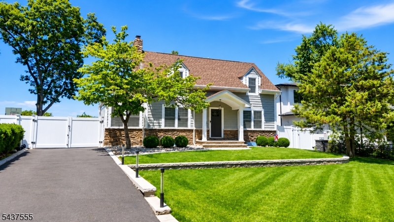 Move-in ready home on one of Paramus's most elevated streets, offering extensive upgrades throughout. Two-tier hardscaping, mature landscape lighting, a covered patio, and parking for approximately five vehicles complement a driveway leading to an attached two-car garage with automatic openers. Oak hardwood floors extend across the first and second levels. The living room includes a gas fireplace. LED recessed lighting is installed on the upper level. The kitchen is equipped with a six-burner range, wall oven, refrigerator, beverage refrigerator, dishwasher, microwave, vented exhaust hood, and pantry. Two-zone HVAC (heating and cooling) with smart thermostats serves the home, supported by a 2022 furnace, 2022 water heater, and Aprilaire whole-house humidifier. A whole-house Generac generator, Aquasana whole-house water filtration system, basement dehumidifier, and updated 200-amp electrical panel complete the mechanicals. Five-zone underground irrigation system services the grounds. The primary suite includes a bath with Mr. Steam steam shower and radiant heated floors, plus an air-conditioned walk-in closet. The hall bath also features radiant heated flooring. The finished basement offers laminate flooring, dedicated heating and cooling, and washer/dryer included. Convenient to Bergen County shopping, dining, and major commuter routes.