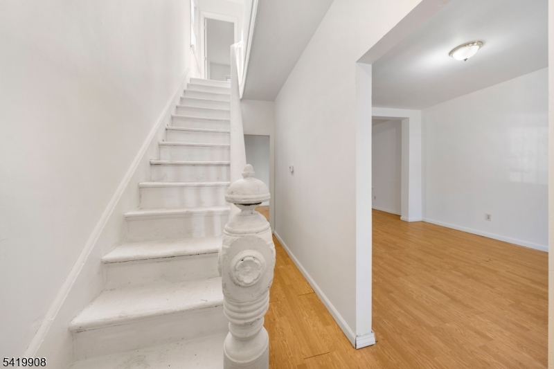 Welcome to this charming and affordable home in Elizabeth, offering a great opportunity for buyers looking for space, value, and potential. The ground floor features a spacious living room and dining room combination, creating an open and inviting layout perfect for everyday living and entertaining. The kitchen offers plenty of space and functionality, ready for your personal touch. Upstairs, you'll find three generously sized bedrooms along with an updated full bathroom, providing comfort and convenience. A full finished attic adds valuable extra living space ideal for a home office, guest area, or additional bedroom. The partially finished basement includes another full bathroom, offering even more flexibility for recreation, storage, or extended living space. With low taxes and an affordable price point, this home is a fantastic option for first-time buyers or anyone looking to get into the market.Conveniently located just one and a half miles from the train station for an easy NYC commute, and close to shopping, dining, and major routes, this property combines space, practicality, and value making it a great place to call home.