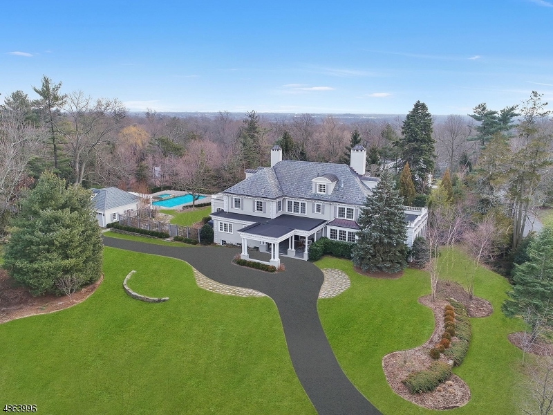 This luxurious and stately private estate, ideally situated on the preeminent street in Short Hills nestled on nearly two tranquil acres, awaits visitors at the end of a majestic drive and creates a commanding presence. The current owners embarked on a major transformation that has become an architectural tour de force. With guidance from Hiland Hill Turner & Diane Hoffman AIA, everything is new offering a grand residence that is timeless yet delightfully warm and inviting, perfect for both entertaining and daily living. The reception hall with front to back views, soaring ceilings, grand fireplaces, chef's kitchen, first floor office, media room, luxurious master suite, ensuite bedrooms, radiant heat, expansive grounds, spectacular pool with pool house and built-in generator all add to the home's cachet.