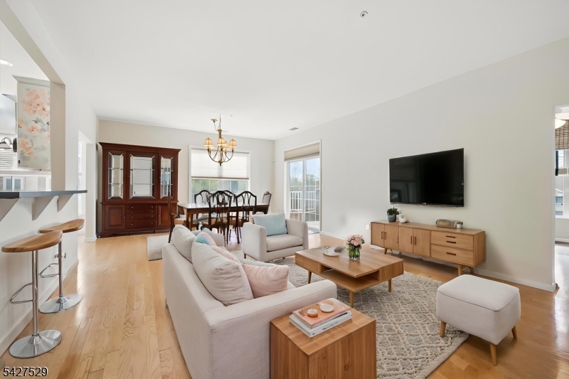 Beautiful Windsor E corner unit in the private Jackson Building, located within the highly desirable Fox Hills active 55+ gated community offering a resort-style lifestyle and outstanding amenities. This spacious 3rd-floor home features 2 bedrooms, 2 full baths, plus a flexible bonus room ideal for an office, den, or guest space. A welcoming foyer leads into a bright, open layout with wood flooring throughout the living and dining areas. The kitchen offers ample cabinetry, a breakfast nook, and an easy flow for everyday living and entertaining. The large primary suite features 2 walk-in California closets and an en-suite bath with a stall shower, double vanity, and soaking tub. The second bedroom is enhanced by gorgeous built-ins, adding both style and functionality. A coat closet, pantry, laundry closet, private balcony, 1-car garage, storage area, and additional outdoor parking complete this wonderful home. Fox Hills offers 24-hour gated security, elevators in each building and the clubhouse, shuttle/jitney service to shopping, and an impressive 25,000 sq. ft. clubhouse with indoor and outdoor pools, hot tubs, tennis/pickleball courts, fitness center, bocce, shuffleboard, billiards, card/game rooms, social clubs, greenhouse, and garden plots. Conveniently located minutes from Rockaway Mall, Atlantic Health facilities, dining, and major highways.