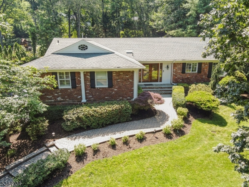 Welcome to your beautiful home in prestigious Short Hills, Deerfield section! Set on an expansive 0.46-acre lot, this residence offers a serene retreat with lush, manicured landscaping, private patios, and a heated in-ground pool perfect for sophisticated entertaining or tranquil relaxation. Inside, you'll find soaring vaulted ceilings, gleaming hardwood floors, and abundant natural light from skylights. The chef's kitchen is a showpiece with a new Thermador cooktop and Bosch dishwasher, seamlessly blending style and function for culinary enthusiasts. The spacious primary suite provides a peaceful sanctuary, while the walkout lower level features versatile office space, a recreation room, a full bath, and direct access to the oversized two-car garage. This home has been thoughtfully updated with a brand-new pool heater and water pump, two new HVAC condensers, two new humidifiers, a new furnace, and a new washer and dryer. Additional features include a central vacuum system, three-zone air conditioning, and an underground sprinkler system. Ideally situated near top-rated Millburn schools, boutique shopping, and NYC transportation, this home offers the perfect blend of refined living and everyday convenience. Discover your fresh start in a home where elegance meets thoughtful updates at every turn