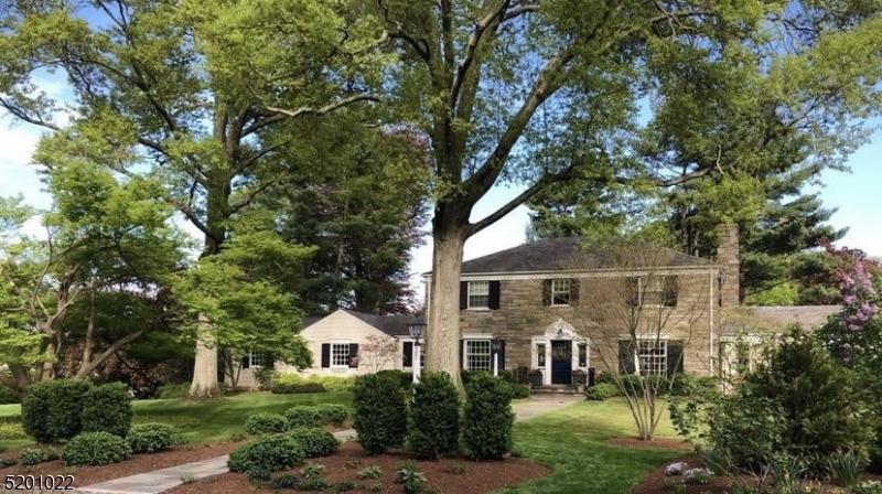 Welcome to this timeless beauty, situated behind "The Wall" in Madison's coveted Hill Section. This 5 BR, 3 BA, 3 half BA home has been stunningly designed while maintaining its period-appropriate charm. As soon as you step inside, you are welcomed by a generously sized foyer and a wide center hall.  The dining room is adjacent to a custom, gourmet kitchen which features a magnificent Danby marble countertop and backsplash, a large center island, designer lighting, and an eating area. All of this flows seamlessly into the incredible family room which hosts a stone-front wood-burning fireplace, a spectacular bay window with a window seat, and a bar area with a wine refrigerator and custom cabinetry. An inviting, yet, large living room with a gas fireplace, crown molding, and french doors to the screened patio, is the perfect spot for hosting just about any occasion. Off of the living room is a sun-drenched office with custom built-ins and french doors, opening to the bluestone patio, outdoor kitchen, and fire pit. The finished basement is another amazing area to entertain or lounge. Large enough for ping pong and pool table competitions, you might not get your guests to leave. Another "libation station" is perfectly situated on this level. The second floor has 5 BRs and 3 BA. The primary BR has a large custom walk-in closet and custom bathroom. All of this is showcased on nearly an acre of professionally designed landscape.