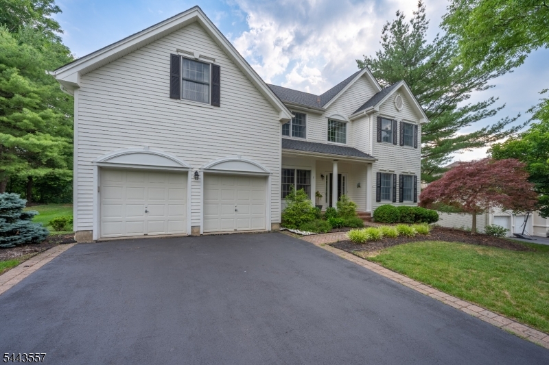 Elegant, light-filled, and beautifully connected to its natural surroundings, this distinguished home offers a refined blend of architectural character, modern comfort, and timeless warmth. A dramatic two-story foyer with an open staircase sets the tone, leading to gracious formal living and dining rooms with hardwood floors and views of the surrounding woodlands. The inviting first-floor library provides a quiet retreat, while the expansive family room is filled with natural light from walls of windows and anchored by a handsome brick fireplace.The well-appointed kitchen features a center island, stainless steel appliances, a new induction cooktop, a double oven, and a sunny breakfast area overlooking the picturesque backyard. The main level also offers a butler's pantry, main-floor laundry, and seamless access to outdoor dining on the paver patio. Upstairs, the spacious primary suite is a true retreat, complete with a serene sitting room, separate workout room, two walk-in closets, plantation shutters, and a luxurious bath with soaking tub and stall shower. Three additional bedrooms and a full bath complete the second level. The professionally finished basement expands the living space with a large open recreation area, a separate room with closet, a full bath, and unfinished storage space. Additional highlights include two brick fireplaces, custom-designed window treatments, a motorized foyer chandelier. new roof (2024) and new washer & dryer, brand new hot water heater.