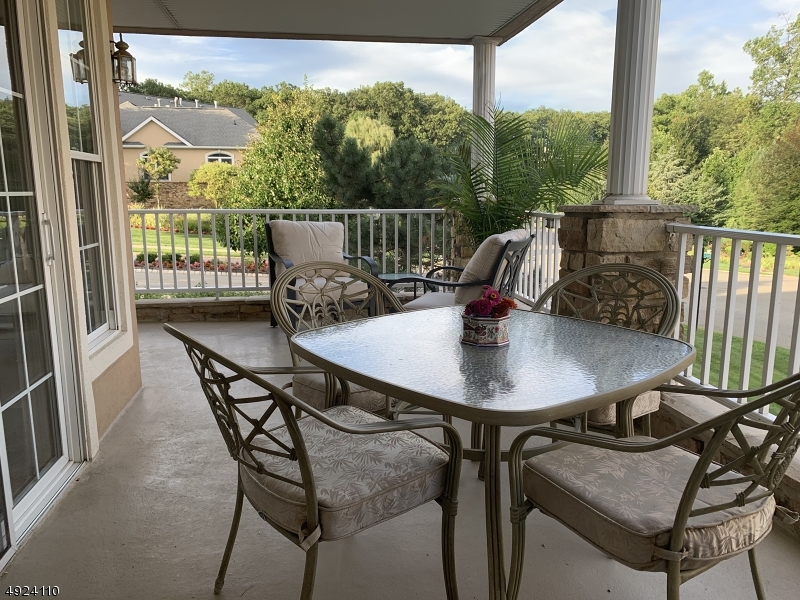Upbeat and refreshed end unit bursting w/natural light located across from the 26,000 sq ft clubhouse and 2 pools.Eat-in Kitchen w/granite, SS appliances, subway tile, 3 entries to covered balcony .Freshly painted interior,new carpet in the bedrooms  Master w/2 walk-ins, huge bath with stall shower, soaking tub and dual sinks. Second bedroom w/reading nook adjoins a full guest bath. Office w/french doors and entry to balcony.  New Central Air 7/19  w/5 yr warranty. Engineered hardwood floors in living/dining rm. Full sized stackable washer dryer. Lovely lobbies for gatherings. Amazing surrey service, water and trash included w/HOA. 24 hr gate keepers. Green house, tennis/pickleball, billiards, saunas, bocce,... and social clubs galore  2 garage parking spaces adjoin  storage units. One yr home warranty