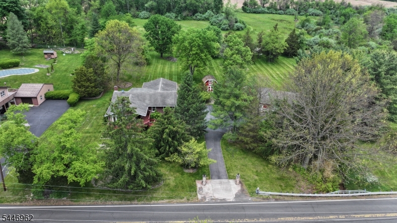 Mechanics Dream & Multi-Gen Estate on 2.7 Park-Like Acres Escape to your own 2.71-acre private sanctuary, where a tranquil park-like setting meets unmatched utility. A scenic creek meanders through the tree-lined acreage, creating a peaceful outdoor oasis. This unique property features a spacious main home, a self-contained in-law suite addition, and an extraordinary setup for car enthusiasts.The main residence offers ground-floor living areas with effortless walkouts to the lush grounds, a large eat-in kitchen, and a half bath. Upstairs features 3 bedrooms and 2 full baths. The attached in-law suite addition provides excellent flexibility, complete with its own living room, full kitchen, and full bathroom.The outdoor infrastructure is a mechanic's dream, BOAsting 3 outbuildings. The star feature is a massive 3-bay garage equipped with 2 heavy-duty, above-ground automotive lifts. A large carport structure and extra outbuilding offer endless space for vehicles, BOAts, or a commercial-grade workshop.Perfectly positioned, this rare property offers rural serenity without sacrifice. Enjoy total privacy while remaining just minutes from major commuter highways and routes. Top-rated local school system. Don't miss this one-of-a-kind estate!