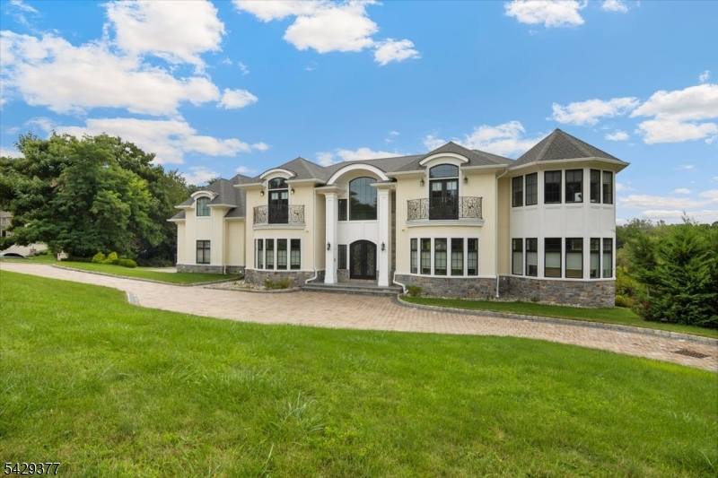 Beautiful custom-built 5-bedroom, 6.1-bath home set on just under an acre, offering exceptional craftsmanship, scale, and privacy located in the prestigious Bell Air section of Livingston. This residence features custom moldings, white oak flooring, oversized rooms, abundant windows, front and rear staircases, and high ceilings throughout. Three fireplaces throughout the home add warmth and elegance. The heart of the home is a high-end custom kitchen with many slide-outs and drawers, Wolf and Sub-Zero appliances, and a striking designer hood. Each bedroom includes its own private bath, while the primary suite offers a spa-like bathroom, sitting room with fireplace, and generous walk-in closets. A finished walkout basement expands the living space with kitchen counters, full bath, possible bedroom or office and French doors leading to the patio. The backyard is a true retreat with an inground heated saltwater pool & hot tub, and total privacy. Additional highlights include a three-car garage, circular - paverstone driveway, Sonos speaker system throughout most of home including outside and whole-house generator. A rare opportunity to own a thoughtfully designed luxury home offering comfort, function, and resort-style living.
