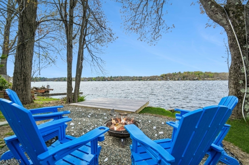 Lakefront living at its finest! Welcome to this charming Dutch Colonial perfectly positioned to capture the breathtaking views of Upper Greenwood Lake. This sun-soaked home offers the ideal blend of character, comfort and thoughtful updates. The second floor features three spacious bedrooms with generous storage, while the home includes two full bathrooms and a versatile walkout lower level - perfect for additional living, a home office, or guest area. Extensively renovated, this home boasts a beautifully updated kitchen with new cabinetry and stainless steel appliances, along with refreshed bathrooms throughout. Additional newer upgrades include newer windows, a new front door, outdoor hot tub, stone facade, new washer & dryer and a recently updated oil tank in the basement. Enjoy serene views, abundant natural light and the opportunity to live the lakefront lifestyle! Close to the UGL Clubhouse and Beach-an ideal spot to watch the annual fireworks show. Live where others vacation with boating, jet/water skiing, kayaking, and fishing in summer, and snowmobiling, ice skating, and ice fishing in winter. Just an hour from NYC and near Warwick's wineries, shops, and restaurants, plus 30 minutes to Mountain Creek and Crystal Springs resorts.