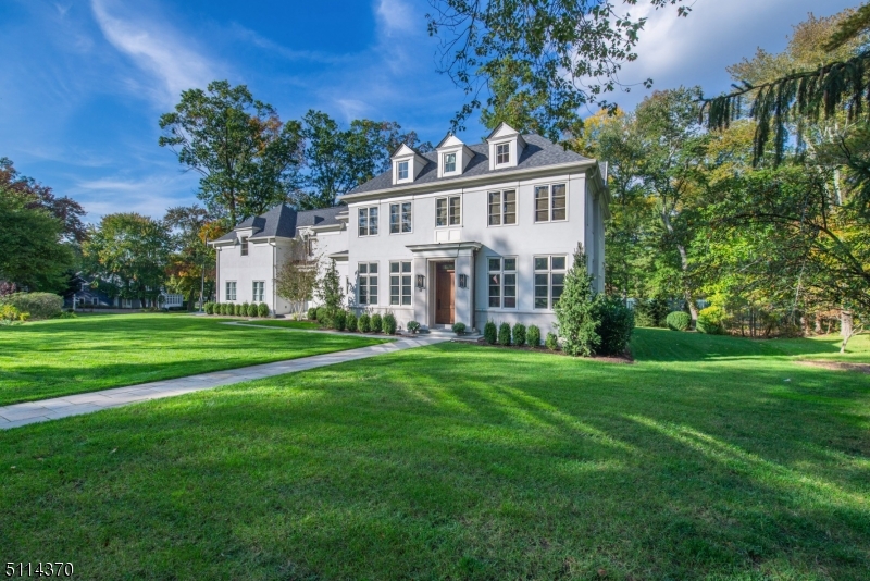 Enjoy the best of everything in this magnificent custom home on a park-like half acre in desirable Short Hills. Designed by architect James Paragano, the must-see home boasts bespoke craftsmanship, premium finishes and chic style. Discover LV engineered hardwood flooring, soaring ceilings, handsome millwork, designer lighting and tall bright windows. Relax in the formal living room, or entertain in the formal dining room that shares a double-sided fireplace with the large family room. The open marble kitchen impresses with Poliform cabinetry and appliances by Le Cornue, Gaggenau, Sub-Zero and Miele. An all-season porch opens to a covered loggia and bluestone patio surrounded by rolling lawns and towering trees. On the upper level, the owner's suite features a spa bathroom with a freestanding soaking tub, rain shower and double vanity. The second floor also includes an oversized suite with a sitting area and private bath, a junior suite and two secondary beds with a Jack-and-Jill bathroom. In the finished basement, you'll find a sprawling rec room, another bed/bath, a gym, office and space for a wine cellar (with plans). Two powder rooms, two laundry rooms, mudroom. Extensive upgrades include multi-zone HVAC, Sonos-ready with speakers inside and out, irrigation, a security system, exterior Ring cameras, a basketball court, a three-car garage and more. Located on quiet, tree-lined streets close to South Mountain, Milburn Pool & Golf, and the Short Hills train station.