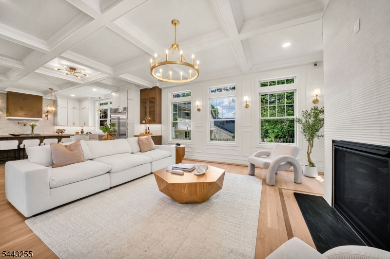 Stunning new construction in the heart of Ho-Ho-Kus offering over 4,600 sq ft of thoughtfully designed living space with 5 bedrooms and 6 full baths across three finished levels. A dramatic 23-foot coffered foyer welcomes you into elegant interiors featuring 10-foot ceilings, custom millwork, and wide-plank white oak floors. The designer kitchen is appointed with custom cabinetry, Taj Mahal quartz countertops, an oversized center island, and a premium Sub-Zero and Wolf appliance suite. The open-concept layout is ideal for entertaining and includes a first-floor en-suite bedroom perfect for guests or a home office. The luxurious primary suite features custom walk-in closets and spa-inspired bath with radiant heated floors and Carrara marble finishes. Additional highlights include a finished walkout lower level, smart home technology, whole-home sound system, multi-zone HVAC, Hardie Plank siding, Andersen windows, a covered terrace, paver patio, and professionally landscaped grounds. An exceptional offering that blends timeless craftsmanship with modern luxury in one of Bergen County's most sought-after communities.