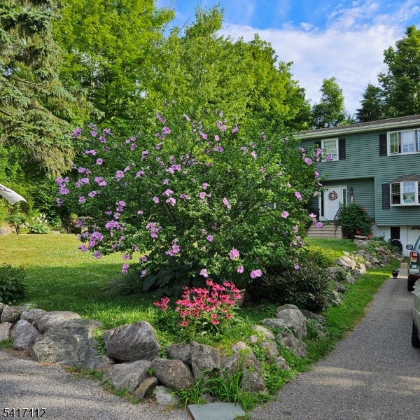 Enjoy the feel of lake living in this lovely home. Ideally situated near the lake, beach, and ball field, this property offers the perfect setting for relaxation, recreation, and year-round enjoyment. The main level features a spacious eat-in kitchen with beautiful cabinetry, ceramic tile backsplash, and a charming dining area with lovely lake views. A bright family room also captures scenic lake views, while a comfortable living room and convenient half bath complete the first floor. Hardwood floors run throughout the main level, adding warmth and character. Upstairs, the primary bedroom offers a walk-in closet, tranquil lake views, and a private full bath with a jetted tub. The second floor also includes a second full bathroom, laundry area, dedicated office space, a second bedroom, and a versatile den currently used as a third bedroom. Additional highlights include a bright interior, ductwork in place for central air, recessed lighting, new driveway, paver walkway and patio, new water heater (2026) and newer well equipment. The basement, with access off the driveway, provides excellent storage space.With the lake just moments away and nearby access to the beach and recreational fields, this home offers the perfect blend of comfort, convenience, and year-round outdoor enjoyment. Don't miss this wonderful opportunity to enjoy lake-style living!