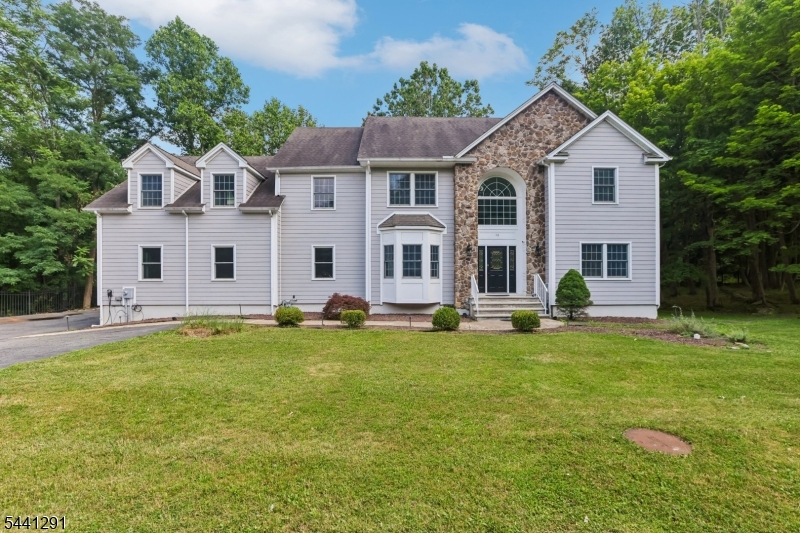 Rare opportunity to own this truly unique custom home set on a private property surrounded by preserved land with direct access to nearby Randolph Trails. This versatile 4-bedroom, 4.5-bath residence offers exceptional flexibility accommodating home offices, guest accommodations, and future customization. A dramatic two-story foyer welcomes you into spacious interiors featuring soaring ceilings, abundant natural light, and oversized rooms throughout. The first level includes a family room with wood-burning fireplace, private bedroom with full bath, powder room, office space, and an expansive great room with endless potential as a game room, media room, home theater, or recreation space. The second level features a spacious kitchen open to a large great room, plus three additional bedrooms, full bath, laundry room, and office, offering ideal separation and flexibility of space. The finished walkout basement expands living options with guest or office space, full bath, summer kitchen, and abundant storage. Outdoor living includes a spacious deck overlooking a beautiful nature back yard. A private pathway provides direct access to Mt. Freedom Avenue. Additional highlights include durable no maintenance Hardie Board siding, 6-foot privacy fencing, excellent curb appeal, and a rare setting combining privacy with convenience to shopping, dining, schools, and major commuting routes. A truly one-of-a-kind property offering unmatched flexibility, space, and potential.