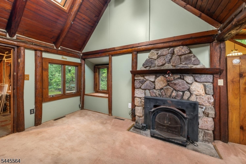 Charming LOG CABIN Home in Greenwood Lake's sought after Lakeside Community Assoc.  You will LOVE the privacy of this adorable cabin home, nestled in the woods. Enjoy activities year round.  Great open floor plan with beautiful loft bedroom! Eat in country kitchen and woodstove in the living room for cozy winter nights.  The bath has a large soaking tub. The back porch feels like your in a tree house and can offer a multi-purpose use. Why rent when you can own your own cozy house?  Come add your finishing touches to make this place your own. The optional $500 membership per year entitles you to use of the private with clubhouse events and beach on the BIG LAKE! Kayak racks available for a small additional fee. NYC commuter bus a short walk from the home. Minutes to Warwick, and its award winning restaurants, wineries, drive-in and shopping.