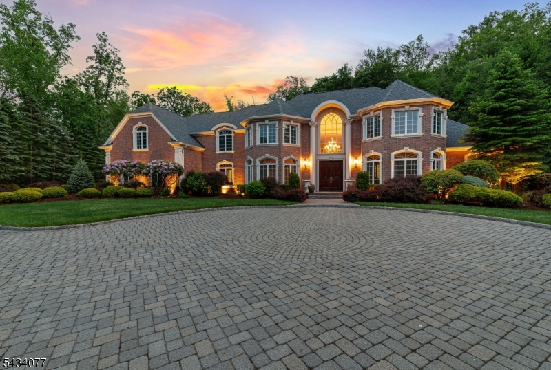 Set within the prestigious Rio Vista community and surrounded by the natural beauty of the Ramapo Mountains, this exceptional 5 bedroom, 6.1 bath Colonial was built with timeless quality and craftsmanship that still feels as impressive today as the day it was completed. Privately set on a rare 2-acre builder?s lot backing directly to Campgaw Mountain Reservation, the property offers an extraordinary sense of peace and privacy. A circular paver driveway and grand two-story marble entry create a striking first impression, while rich hardwood floors, coffered ceilings, custom moldings and floor-to-ceiling windows bring warmth and sophistication throughout. Designed for both elegant entertaining and everyday living, the home features formal living and dining rooms, a dramatic great room with stone fireplace, private office and gourmet kitchen with breakfast area. The first-floor primary suite overlooks the courtyard and resort-style pool, creating a true private retreat. Outside, bluestone patios, lush landscaping and surround sound throughout the home and pool area complete this exceptional lifestyle property.