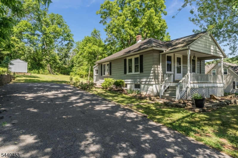 Charming and beautifully updated 2-bedroom, 1-bath ranch situated on a spacious 0.77-acre lot! This move-in ready home features a bright living room, dining room, and an eat-in galley kitchen with new cabinetry and countertops. Fully renovated bathroom offers a tiled shower with glass doors. Freshly painted throughout, the home showcases wood flooring. Full walkout basement with a laundry area and abundant storage space. Outside, you'll find two storage sheds, a large front porch perfect for relaxing, and an expansive backyard complete with a fire pit. Enjoy the peaceful setting while remaining just minutes from major commuting routes, shopping, and restaurants.