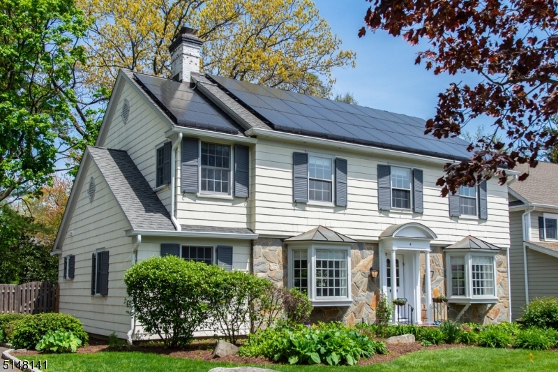 Beautiful curb appeal welcomes you to this Stunning Center Hall Colonial situated in one of the most desirable areas of Upper Montclair.  With custom detailing and upgrades thruout, this home has been meticulously maintained by the current owners.  The 4 BRs and 3 1/2 baths offer a 1st floor inlaw or au pair suite with full bath; the open floor plan features hardwood throughout - Gourmet Kitchen with extensive custom cabinetry with glass displays, granite, Breakfast bar and open to a 22x18 Family/Great room with built ins, recessed lighting and access to the rear yard perfect for entertaining.  The arched entries to LR (wood burning custom surround fireplace, bay window) and DR (shadowbox molding, corner period built ins, bay window) create a traditional/contemporary ambiance that will impress the most discriminating buyer.  From the Solar panels - owned not leased - to the smart thermostats, system upgrades throughout and radiant floors, to the incredible MBR Suite - 20x13 plus 11x7 Sitting area and 14x13 luxurious master bath w/ oversize double shower, dual vanities & 2 customized wi closets, this home has so much to offer.  The lower level 19x12 Recreation room/office/flex space and powder room is adjacent to the weight & utility/laundry rooms. With newer ACs and a high end Bederus furnace system - every detail in this property is quality.  Brookdale Park at end of block - city bound buses and midtown direct trains, 'Mt. Vernon' offers a wonderful community and lifestyle!