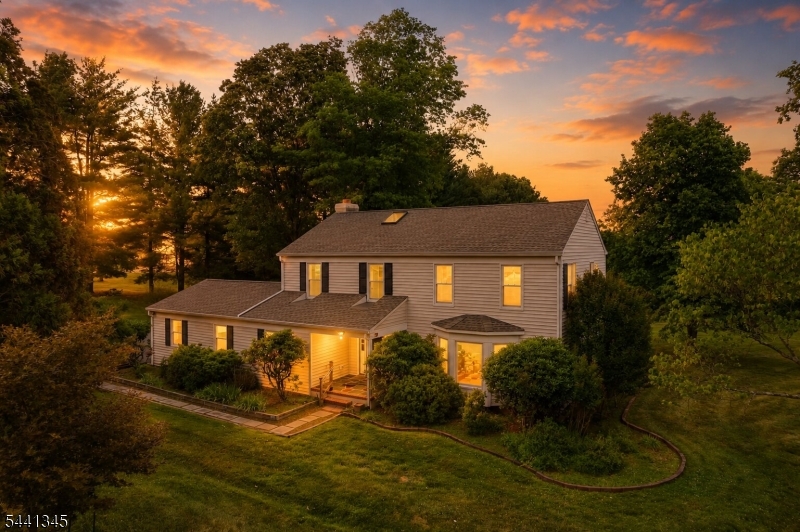 Welcome to 102 Robin Way - first time on market by its original owners! Situated on a private & level 1.87 acre corner lot, this center hall colonial offers 4 bedrooms, 2.5 bathrooms, a 2-car garage, & a finished basement. Enter through the covered porch into a welcoming foyer with slate-style stone flooring. Natural sunlight fills every room, highlighting the hardwood floors throughout the home. The formal living room w a bay window flows into the formal dining room, while the spacious kitchen features a pantry, eat-in area, & sliding doors leading to the rear deck. Just off the kitchen, the family room offers a cozy wood-burning fireplace. BONUS first-floor office. Powder room & laundry room complete this level. Upstairs, a large skylight brightens the staircase and second floor. All four bedrooms feature hardwood flooring, including the spacious primary suite with a walk-in closet & private bath. The finished basement is thoughtfully divided between a recreation area and separate storage space. Outside, enjoy the expansive deck with a partially covered section and built-in seating overlooking the serene backyard. The level lot provides exceptional privacy yet is part of a beautiful street and has endless possibilities for outdoor enjoyment. Located in a desirable neighborhood with top-rated schools, this is a rare opportunity to own a lovingly cared-for home in the heart of Neshanic Station. Recent updates include Roof (2020), Water Heater (2023), and newer windows!