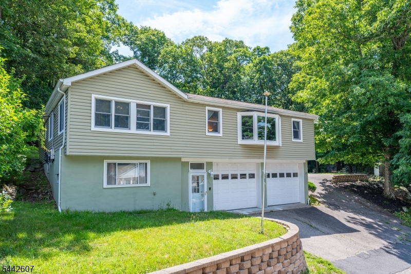 Welcome to 335 Elmira Trail, a spacious Hopatcong raised ranch offering the kind of flexibility that is hard to find in this price range. Set just minutes from Lake Hopatcong, this 3-bedroom, 2.5-bath home features generous living space, comfortable room sizes, hardwood flooring, and a bright main living area filled with natural light.The updated eat-in kitchen offers high ceilings, a skylight, breakfast bar seating, and an easy connection to the formal dining area, creating a practical layout for everyday living and entertaining. Outside, the home continues to impress with a private deck, backyard gathering space, storage shed, and extensive parking.A major highlight is the oversized heated garage and driveway setup, offering parking for 12+ vehicles with additional side driveway space. This is an ideal setup for car enthusiasts, contractors, tradespeople, hobbyists, boat owners, or anyone needing extra room for vehicles, tools, equipment, or recreational storage.Recent improvements include renovated bathrooms, newer furnace, mini-split air conditioning, whole-house water filtration system, and water softener. Enjoy convenient access to Route 80, Route 46, Route 10, and all that the Lake Hopatcong area has to offer, including boating, fishing, beaches, waterfront dining, hiking, skiing, golf, and year-round recreation.A standout opportunity for buyers looking for space, updates, parking, and lifestyle in one complete package.