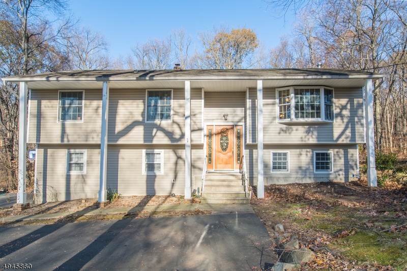 PROFESSIONALLY CLEANED TOP TO BOTTOM, INSIDE AND OUT, PROFESSIONALLY LANDSCAPED & PROFESSIONALLY POWER WASHED (siding & roof). Lots of Generous Room Sizes to Spread Out & Make Your Own! Layout offers versatile options! Ground level IN-LAW SUITE w/sep entrance & full kitchen! GREAT house for entertaining or everyday living. Hardwood Floors. Great living space w/wood burning stove. Oversized family room w/high ceilings appointed w/custom palladian windows & sliding glass doors leading to 2 story, trex style deck. Super functional kitchen w/NEW SS appliances, quality wood cabinets, granite & bfast bar. Opens to dining & living areas. 3 large bedrooms & 2 full bath upstairs includes the master suite w/private access to the back deck. 4th bedroom & bath on lower level. Fully equipped in-law suite on ground floor w/sitting area & walkout to backyard. Over 2500 square feet. Heated 2 car garage w/workshop. Plenty of storage space in the attic, garage or storage shed. The backyard is large, level and private. Over a full acre. Above ground pool. An ideal spot to relax & enjoy life. Just a 5 min drive to the bustling Downtown, NYC Direct Mass Transit & easy access to major highways such as 80, 10, 46 &287. Affordable taxes especially for home size. Anderson double pane windows & exterior doors. Top rated schools. Amazing opportunity & Value. MAKE AN OFFER!