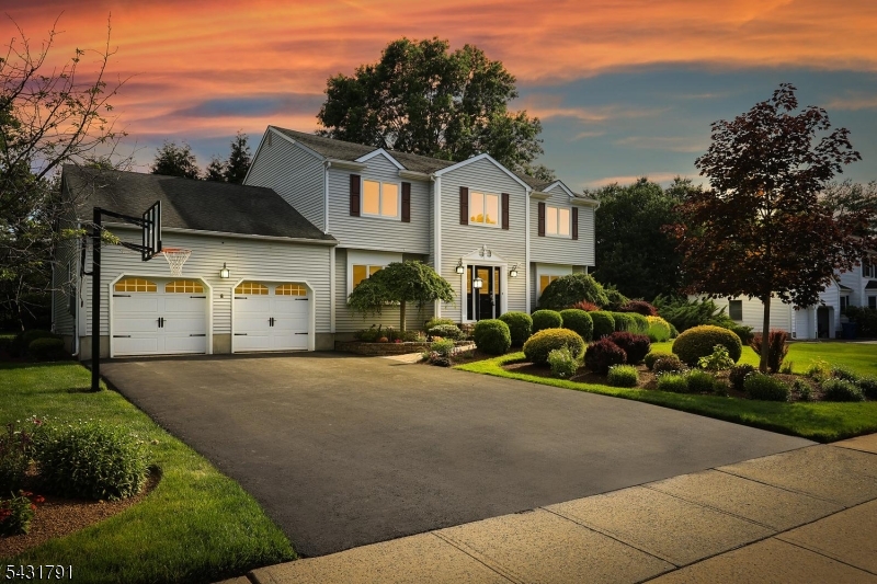 Beautifully maintained & move-in ready, this spacious 5-bedroom, 2.5-bath home combines timeless charm, thoughtful updates, & versatile living space. The main level showcases hardwood flooring, recessed lighting, crown molding, shadow box trim, custom built-ins, & a cozy wood-burning fireplace. The updated kitchen features granite countertops, a two-tier center island, two pantries with pull-out shelving, pot drawers, a 5-burner gas range, microwave, garbage disposal, and newer appliances, including a refrigerator (3 years) and dishwasher (2 years). A sliding glass door opens to the covered screened porch, creating seamless indoor-outdoor living. The first-floor fifth bedroom offers flexibility as a home office, guest room, or playroom, while the mudroom with built-in bench and hooks adds everyday convenience. Upstairs, the primary suite features hardwood flooring, a ceiling fan, a walk-in closet with custom organizers, & an updated en-suite bath with dual granite vanities, an oversized shower w/ dual shower heads, & a built-in bench. Additional highlights include a partially finished basement, whole-house generator, HVAC (2019), & hot water heater (2019). Set on a beautifully landscaped lot with a manicured lawn, the spacious backyard is ideal for entertaining, featuring a large deck and covered screened porch with ceiling fan perfect for summer gatherings or relaxing evenings. A rare combination of space, comfort, & updates, this turnkey home is ready for its next owners.
