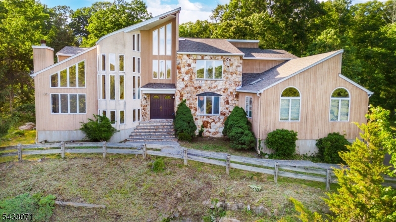25 Woodchase Lane, Kinnelon, NJ ? a custom-built sanctuary blending elegance and comfort on a serene, sought-after street. This luxurious residence offers 5 spacious bedrooms, 4 full baths, and 2 half baths, designed for effortless living and impressive entertaining. A soaring grand room anchors the main level with abundant natural light and refined architectural detail, flowing seamlessly to a gourmet-ready layout and inviting outdoor spaces. The finished basement elevates leisure with expansive zones ideal for a home theater, game area, gym, or wine lounge.Recent upgrades include a brand new roof for peace of mind and polished curb appeal. Thoughtful craftsmanship is evident throughout?handsome millwork, generous ceiling heights, and well-planned sightlines that balance openness with intimacy. Retreat to a serene primary suite with a spa-style bath and generous closets, while secondary bedrooms provide en-suite or nearby bath access for ultimate convenience.Outdoors, enjoy lush grounds perfect for gatherings, grilling, or quiet mornings with coffee. Storage and utility are effortless thanks to the 3-car garage and ample additional parking. Located in picturesque Kinnelon, known for natural beauty, lake communities, and top-rated schools, this home delivers a rare combination: timeless design, modern updates, and spaces that adapt beautifully to work, play, and relaxation.Discover refined living at 25 Woodchase Lane?where quality, comfort, and style come together.