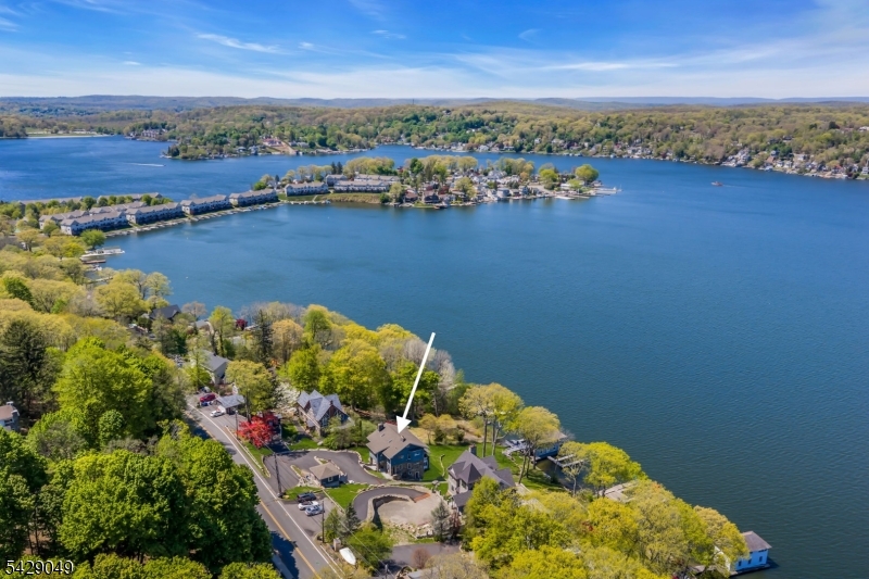 Built circa 1904 as a summer retreat by Gustav Stickley, this extraordinary Lake Hopatcong estate is one of only three privately owned Stickley-designed homes known in NJ. Set along the coveted Windemere waterfront from the lake's golden resort era, it offers a rare blend of architectural significance and premier lakefront living. Rich in authentic Arts & Crafts detail, the home showcases handcrafted millwork, quarter-sawn white oak, wide plank flooring, original beams, custom built-ins, amber glass, original baked tiles, and expansive lake-facing windows. Every element reflects Stickley's philosophy of simplicity, craftsmanship, and harmony with nature. Spanning 4 finished living levels, the residence invites you to step back in time while enjoying timeless comfort. A covered porch overlooks the .64-acre setting and a finished 2-story boathouse, creating a picturesque waterfront retreat. Take in summer regattas and a front-row seat, 100ft of waterfront views of Lake Hopatcong's fireworks. A true legacy property where American design history meets refined lakefront living, offering a once-in-a-lifetime opportunity to own a piece of NJ's most iconic shoreline. Additional notables of interior and exterior upgrades, floor plans, an interior walk-through tour, and township approvals for an in-ground pool. Located minutes to major routes, NJ transit rail and just one hour to NYC. Vacation where you live and experience all that lake life has to offer in this four-season community.