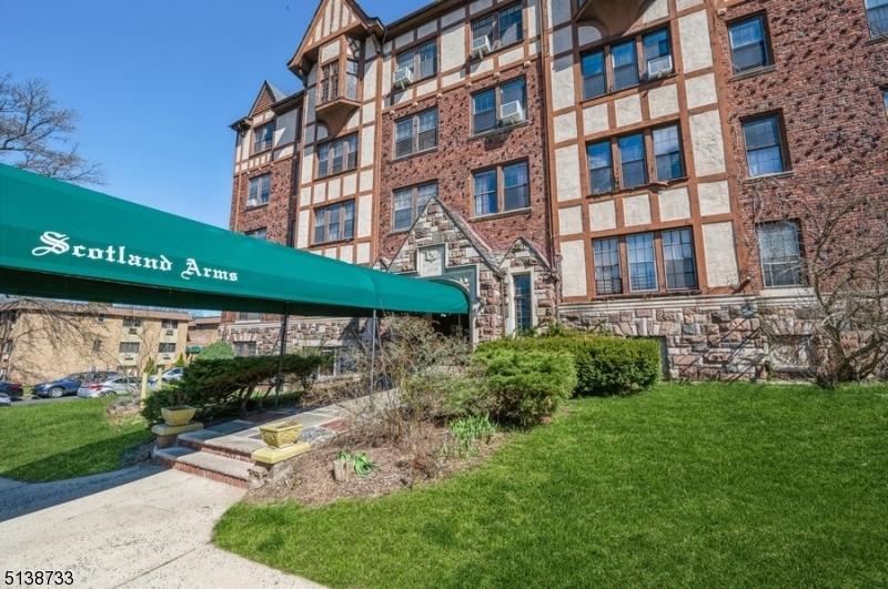 Comfort, quality, and style!Spacious and stunning one-floor condominium with three bedrooms and two full bathrooms is loaded with character and move-in ready! Nestled in a beautiful pre-war building on a quiet street about fifteen miles from Manhattan, it is convenient to Main Street shops and restaurants, New Jersey Transit stops, and huge nearby nature preserves.  The interior of this light-filled residence features high ceilings, Gothic arched doorways, warm hardwood floors, wide base and crown molding, multiple cedar closets, and ceiling fans in most rooms.The foyer opens to a large living room highlighting a charming brick fireplace with a carved wooden mantel. A wide archway opens to the formal dining room with a built-in corner cabinet and swinging door to the bright white kitchen. The kitchen features ample cabinet and counter space and a pass-through/breakfast bar connecting it to the dining room. Down the hall is the large primary bedroom with an en suite bathroom, two additional bedrooms (one with a walk-in closet), and a full hallway bathroom. Old world elegance and charm is on full display in the richly paneled lobby with a wide stairway to the mezzanine level where you'll find a gracious sitting room and elevator access. HEAT AND HOT WATER included in maintenance fee. Portable washer and dryer included plus laundry facility located in Basement area. Just one block away from the NJ Transit Mountain Station stop.