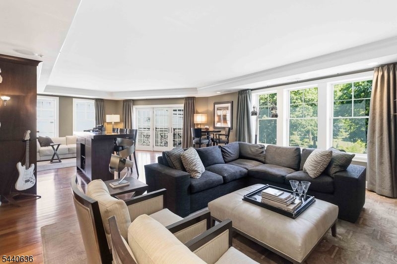 Experience luxury living in this professionally decorated 2 Bedroom, 2.1 Baths, with a bonus large Den in the heart of historic Morristown. With 2,492 Sq. Ft. of living space, this open concept condo is designed for entertaining, offering beautiful Brazilian Cherry hardwood floors, 9 Ft. ceilings, marble bathrooms, gourmet kitchen with separate dining area, a custom bar, spacious bedrooms with plenty of closet space, and a lovely terrace with view of the Morristown Green. Building amenities include Full Concierge service (365 days/year),  24/7 gym, private club room with a fireplace, TV, billiard table and a full catering kitchen.  2 assigned and deeded parking spaces in an attached, temperature controlled private parking garage. Convenient location allows walking distance to fine restaurants, the Green, theatre, movies and NYC train.