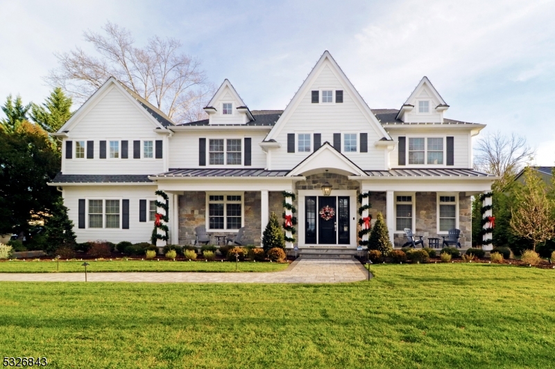 A town standout, this home has been catching the eye of passers by for the 4 years since it was built. The captivating exterior with welcoming front porch is just the beginning! From the moment you enter the home you will marvel how the owner seamlessly tied together modern trends with timeless classics. The space feels grand with a 2 story entry, 8ft doorways, and high ceilings on both the first & second floor. This home is adorned with thick moldings and custom woodwork throughout. The first floor features a formal dining room & living room, a chefs kitchen overlooking the expansive family room, a butlers pantry and a large bedroom with ensuite. Take the foyer stairs or the back staircase to the 2nd floor to 5 additional bedrooms each complete with a spacious closet and 4 with a private bath (1 Jack n Jill). Large primary suite with tray ceiling, fireplace, and sitting room. Three closets and a bathroom fit for royalty complete with intricate tile work and an oversized shower and soaking tub. The basement is full and finished with a full bathroom. Keep your skills sharp all season with the professionally installed Full Swing Sports Simulator.  Finished 3rd floor w/ abundance of windows and a full bathroom. The backyard is a true private oasis. A custom heated pool & fire pit, hot tub, professional lighting & landscaping throughout, makes for year round outdoor gatherings. Additional features: 3 car garage, walk up attic, whole house generator. No detail was left out.