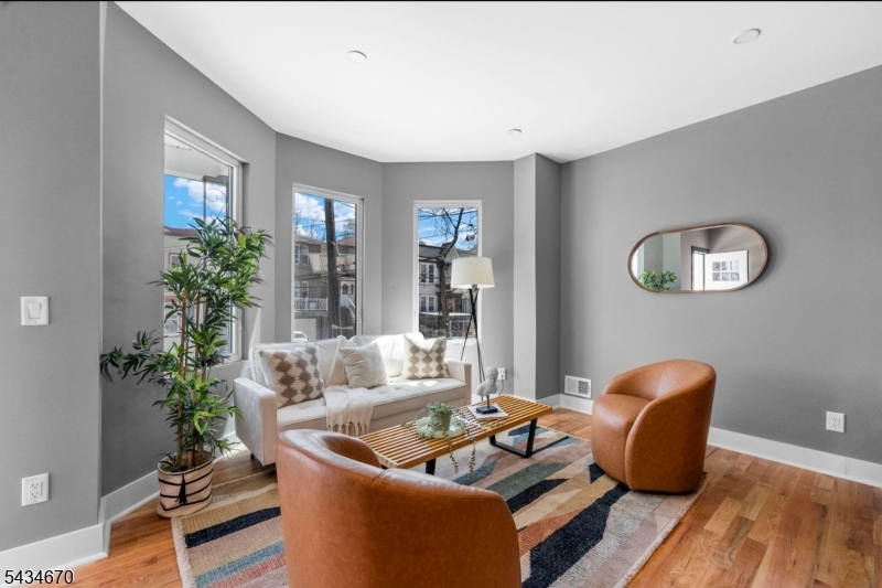 Experience elevated Jersey City living in this spectacular upper-level duplex condominium offering approximately 4 bedrooms, 3 full bathrooms, and breathtaking New York City skyline views.Designed for modern living, this sun-drenched residence features soaring ceilings, oversized windows, hardwood flooring, and a seamless open-concept layout. The chef-inspired kitchen showcases a large center island, premium finishes, and ample storage while flowing effortlessly into the expansive living and dining areas.Wake up to stunning NYC skyline views from the luxurious primary suite, complete with a beautifully appointed ensuite bathroom. The additional bedrooms provide generous space for guests, home offices, or flexible living arrangements.Natural light pours throughout both levels, creating an airy and inviting atmosphere rarely found in condominium living. Every detail has been carefully selected to blend contemporary elegance with functionality.Perfectly situated in Bergen-Lafayette, one of Jersey City's fastest-growing neighborhoods, you'll enjoy convenient access to Liberty State Park, Light Rail service, PATH transportation, Downtown Jersey City, local cafés, restaurants, and Manhattan