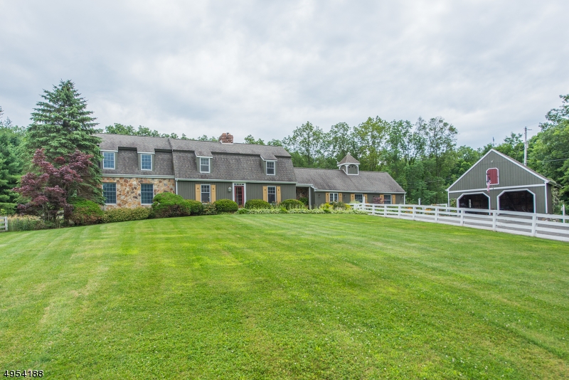 This custom Cape Cod is the quintessential Classic Country Home. Complete with mountain views, tree lined driveway, white picket fence, beautiful gardens, and in-ground pool. Bring your horses. This unique home features Modern updated Eat-in Kitchen with SS appliances, marble countertops and subway tile. Impeccably decorated with modern farmhouse decor. Elegant first floor master w/ adjoining sitting room and beautiful master bath. Entertain in the large formal dining room with wood burning FP and wood beamed ceiling. Cozy up to the 2nd FP in the huge Great Room with lots of natural light. 2nd Floor features 2 bedrooms, middle room Den w/ sliding barn doors. Finished Rec Room in Basement and 2 Car Detached Garage. 6.5 Acres of hay fields and backs to woods for ultimate privacy. Welcome to the country!
