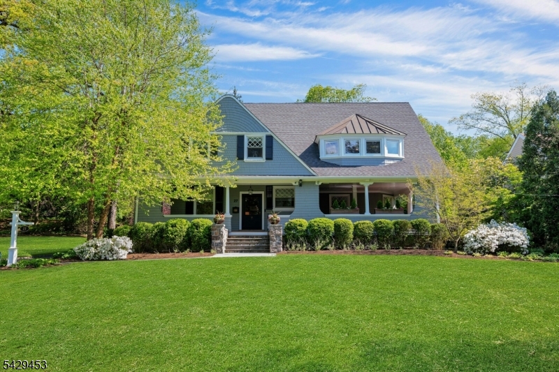 Exquisite Colonial set on nearly .75 acres, blending timeless architectural character with modern livability, exceptional custom craftsmanship and an abundance of charm. Extensively renovated and expanded, this remarkable 7+  bedroom, 5 full and 2 half bath home offers over 5,685 sq ft of living space plus approximately 700 sq ft of porches and a finished lower level. A rare and truly stunning feature is the wrap-around porch serving as the heart of this home, offering timeless charm and seamlessly blending indoor and outdoor living.  Amazing for entertaining and a true Summit gem! The grand foyer features a coffered ceiling and an original oversized glass paneled front door. Gracious living spaces include multiple fireplaces, bay windows, built-ins, formal living and dining room, office/library, and powder room.The 2023 designer kitchen renovation features custom cabinetry, Taj Mahal quartzite countertops and backsplash, Wolf 6 burner cooktop, double ovens, 2 dishwashers, pantry, and an open-concept connection to the great room.The second floor includes 5 spacious bedrooms (3 ensuite bath), including a luxurious primary suite with updated bath, soaking tub, oversized shower/marble, radiant heat, walk-in closet, and built-ins. Laundry room on 2nd fl. Two additional bedrooms, full bath, and bonus room are located on the third floor.Lower level with recreation room, gym, wine cellar and powder room. Bucolic yard, 2-car garage with lift, mature landscaping,1 mile to downtown.