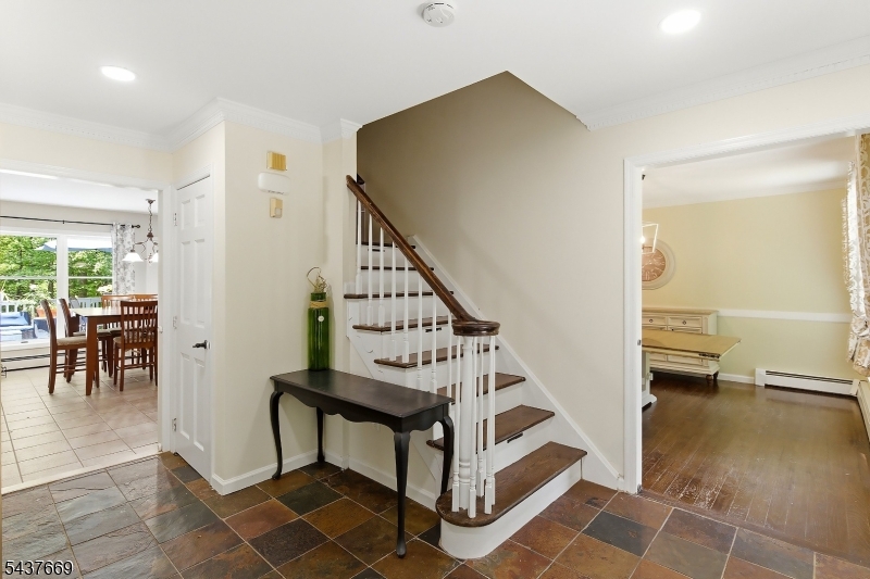 Welcome to 17 Grandview Terrace. This young, modern, and spacious center-hall colonial has it all, catering to a wide variety of lifestyles. Nestled on two quiet acres, the home offers peace and tranquility from the hectic pace of North Jersey life. Enter to a beautiful foyer. On this main level you'll find a light-filled formal living room with French doors leading to the family room with wood-burning fireplace. The eat-in kitchen is the main hub of the home, offering a breakfast bar, eating nook, stainless appliances, and granite countertops. This area offers direct access to the formal dining room, back deck, laundry room, and garage. Rounding out the first floor you'll find a bonus room that can function as an office or guest area, and a powder room. Up to the second floor you'll find a generously sized primary bedroom with en suite bath and huge walk-in closet. This level has 3 additional bedrooms and a stunning full bath with dual sinks, stall shower, and deep soaking tub. The walk-out basement offers amazing additional space, including a rec room, play area, game room with pool table, private bonus room, utilities, storage, and a half bath. Indoor-outdoor living is seamless with a huge deck overlooking the grounds, and ample yard space to play and entertain. Completing the home is an oversized, attached 2-car garage, and extra long driveway with multiple spots for off-street parking.