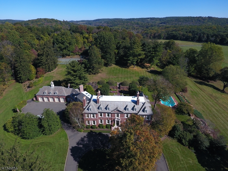 One of Peapack-Gladstone's grand turn-of-the-century-estates. Four Seasons sits majestically on 50 acres of rolling countryside & fenced pastures with breathtaking, unobstructed views. This magnificent brick manor designed by architect James C. Mackenzie & fashioned after a classic Georgian estate. Included in the design is a state-of-the-art 17-stall brick stable w/tack & carriage rms, carriage & guest houses, 3 apts, greenhouse, barn, pool, tennis ct. along with beautiful gardens. Exquisite architectural detail, generous room dimensions & luxurious appointments are the hallmark of this home. Amenities include wine cellar with tasting room, high ceilings, marble & hardwood floors & of course the endless views.  Rental income of approx. $100,000 covers most of taxes!