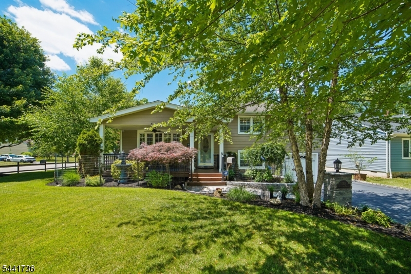 Perfect Union of Meticulously Maintained Indoor & Outdoor Living w/SUNRISE Porch & SUNSET Covered Deck. Charming Curb Appeal on a Tree-Lined Street this 3/4 Bedroom, 2.1 Bath Split Level offers approximately 2,300 sq ft of living space, including a valuable FAMILY ROOM ADDITION plus a FINISHED basement! OPEN-CONCEPT floor plan is ideal for entertaining & seamlessly connects exceptional indoor & outdoor spaces. Spacious KITCHEN features stunning 13-FT CENTER ISLAND, 30 FT of Counter space, Stainless Steel appliances & abundant cabinets. SKYLIT GREAT ROOM w/11 ft HIGH CEILINGS & WOOD-BURNING Furnace/Fireplace.Step outside to COVERED FIBERON Deck overlooking the LEVEL backyard & PAVER PATIO - perfect for dining or relaxing while watching outdoor TV, rain or shine.The second level a few steps up hosts a Primary Bedroom w/Private half-bath, 2 additional bedrooms & a Full Hall Bath. The ground level offers a versatile OFFICE/Potential 4TH Bedroom & FULL Bath, creating the perfect space for guests, extended living, or working from home. FINISHED BASEMENT Rec Room provides even more flexible living space with a large storage room. Additional highlights include a Whole house filter, Reverse Osmosis in Kitchen, Tankless Water Heater, Security Camera system, R13 Insulation, Hardy Plank Siding & much more!!! (see feature sheet) Conveniently located around the corner from Harrison Elementary, Northland Park Tennis/Pickleball Courts & Playground. MOVE RIGHT IN & ENJOY LIFE in LIVINGSTON!