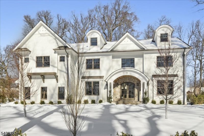 An exceptional Madison offering set on a rare, level .74-acre property in Madison's coveted Hill Section,with over 9500 sq ft of thoughtfully designed living space. The 1st floor is defined by elevated 10-foot ceilings, oversized windows, & abundant natural light throughout. A formal living room showcases custom built-in shelving, while the dining room is enhanced by a sophisticated wine closet ideal for refined entertaining. The kitchen is both timeless & highly functional, appointed w/quartzite countertops, striking pendant lighting, custom cabinetry w/ generous storage, high-end appliances, & a hidden pantry that keeps everyday living beautifully streamlined. Open to the kitchen, the family room is centered around a stone mantel, creating a warm yet sophisticated gathering space. Custom millwork is prominently displayed throughout, including elegant barrel arches and coffered ceilings, complemented by white oak flooring and designer lighting. 7 generously sized BRs, each w/an ensuite bath, include a 1st floor guest suite. A walk-up third floor provides flexible living space, while the finished lower level offers a recreation room, wellness room, second laundry, & an additional bedroom w/a full bath. Designed in collaboration w/ CMM Interiors, the home is rich in craftsmanship and detail throughout. Outdoor living is equally impressive, w/ bluestone patios, a built-in grill area, and a stone fireplace creating a seamless extension of the home's elegant interior spaces.