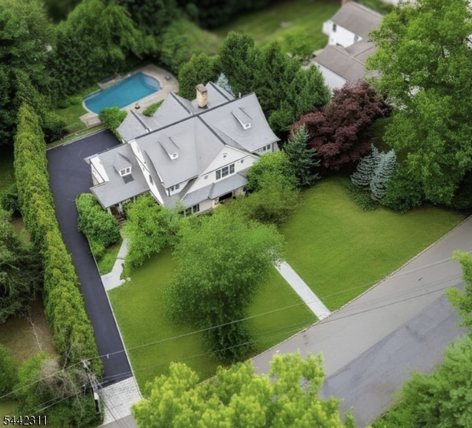 This elegant custom Colonial has all of the luxurious details that today's discerning home buyer expects, including a heated salt water pool/spa, an elevator to all floors & a whole house Generac generator, ideally located on 0.54 level acres within walking distance to top schools (.4 miles to Pingry Lower School & .8 miles to Hartshorn Elementary) & Gero Park (.6 miles). The exterior is cedar siding, there are copper gutters & a slate roof. The inviting front entry leads to a grand entrance hall open to gorgeous family room & large formal dining room w/ custom crown molding & wainscoting. The gourmet eat-in kitchen has top of the line appliances, a center island w/ seating, walk-in pantry & separate sunlit eating area totally open to the family room w/ a gas FP, for the ideal floor plan. This home boasts 1st & 2nd floor primary suites. Both primary en-suite bathrooms have radiant floor heating. A sitting room/office w/ balcony, mudroom, laundry room, & 2 powder rooms complete the 1st level. The 2nd level has 3 generously sized bedrooms, 3 full baths, a 2nd laundry room & large family room/study with a gas FP & balcony. The walkout lower level has high ceilings, a large en-suite bedroom w/ a beautiful full bath, a powder room, a media room w/ a second kitchen & interior garage entrance. Walk out of the lower level to the stunning patio with a built-in outdoor gas grill, private, level backyard with mature plantings & gorgeous pool w/ mature trees providing tremendous privacy!