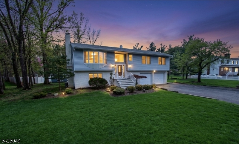 Offered for the first time, this meticulously maintained 3-bedroom, 2.5-bath bi-level home sits on over a serene half-acre lot, delivering the perfect blend of space, comfort, and opportunity. Pride of ownership is evident throughout, with generously sized bedrooms, including a primary bedroom with walk in closet  and a well-designed layout ideal for both everyday living and entertaining.The main level features bright, inviting living spaces with access to a spacious covered  deck overlooking the peaceful backyard perfect for morning coffee or evening relaxation. The lower level offers a versatile layout complete with a summer kitchen, opening to a beautifully finished paver patio, making it ideal for extended living or entertaining guests.With a possible mother-daughter setup and subdivision potential, this property presents exceptional flexibility for a variety of lifestyles or future investment opportunities.Enjoy the convenience of being within walking distance to the scenic trails and natural beauty of Rifle Camp Park and Garret Mountain Reservation, offering year-round outdoor recreation just moments from your doorstep.A rare opportunity to own a lovingly cared-for home in a tranquil setting with endless potential.
