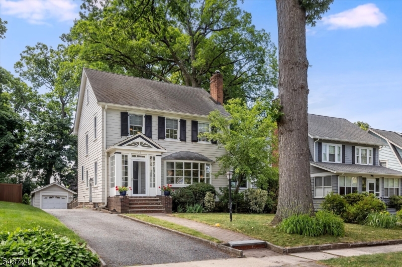 Classic Glen Ridge colonial perfectly positioned in one of the town's most desirable locations, just steps from Freeman Rose Garden, Carteret Park, top-rated schools, and Midtown direct trains to NYC. Filled with natural light and timeless charm, this inviting home offers gracious room sizes, fabulous flow, and the perfect balance of open gathering spaces and private retreats. The spacious living room features a wood-burning fireplace and oversized bay window, while the adjacent  sunroom provides an ideal space for a home office, playroom, or additional living area. The updated gourmet kitchen is appointed with stainless steel appliances including a Viking range, granite countertops, abundant cabinetry, and opens to a sun-drenched great room with skylights overlooking the private, level backyard. Upstairs, the generously sized primary bedroom offers a wall of custom closets, while the updated bathrooms and thoughtful improvements throughout make everyday living effortless. Additional highlights include two- zone central air, and a finished lower level with recreation space, powder room, and generous storage. Exceptional curb appeal, a private backyard, and a premier location make this a wonderful opportunity to enjoy the very best of the Glen Ridge lifestyle!