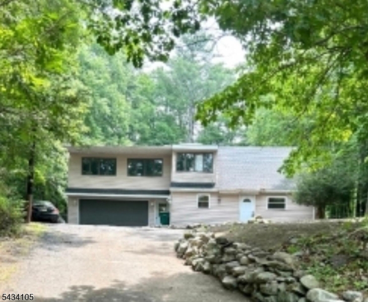Welcome to this 4-bedroom, 2-bath home situated on a private wooded lot offering peace, privacy, and plenty of potential. This home is being sold strictly as-is, where-is and is in need of TLC, making it a great opportunity for buyers, investors, or contractors looking to renovate and add value.The home offers a spacious layout with large windows, generously sized bedrooms, an attached garage, and an oversized driveway for ample parking. Surrounded by mature trees and natural scenery, this property provides a peaceful setting with low taxes and no HOA fees.Bring your vision and make this home your own!