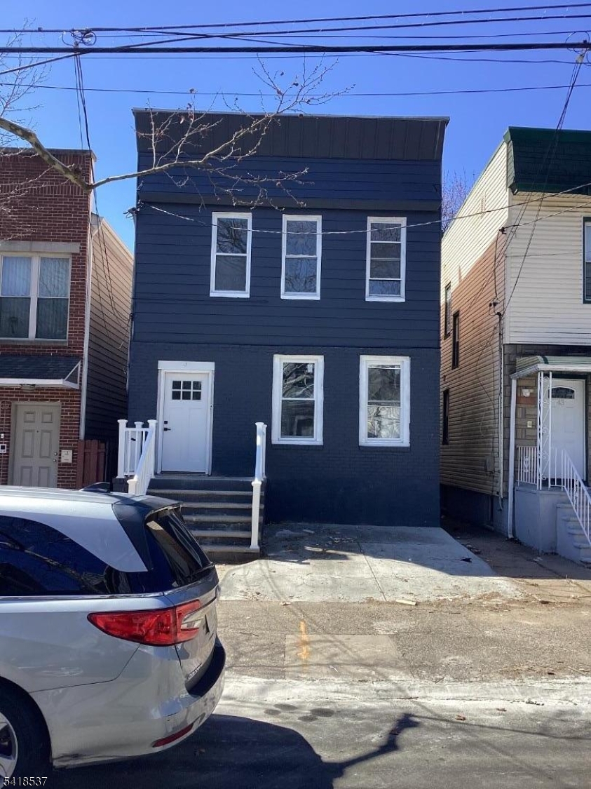 This renovated two-family home features modern, cozy styling with two 3-bedroom units, making it ideal for comfortable living or investment. The property boasts upgraded features including new appliances in both kitchens, stylish baths, new flooring, and recessed lighting. The first floor typically includes a large living room and formal dining area