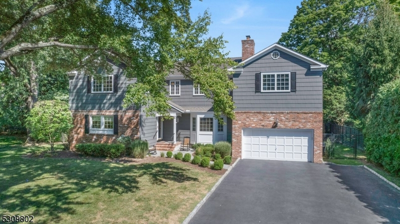 Timeless colonial home located in the sought-after Wychwood section of Westfield. Situated in a peaceful cul-de-sac, this charming property features five bedrooms and four full baths, offering a blend of elegance and comfort. The first floor boasts a gourmet chef's kitchen equipped with premium appliances and a spacious eat in breakfast area. Step outside the kitchen to enjoy the spacious serene, deck overlooking the fully fenced private park-like backyard. Additionally, the first floor includes a cozy den with built-ins, a bedroom, and a full bath. The inviting living room features a gas fireplace and abundant natural light, while the sizable dining room is perfect for hosting guests.Upstairs, you'll find four bedrooms, a walk-in laundry room, and an updated main bathroom with dual sinks. The primary suite impresses with  gas fireplace and a beautifully renovated spa-like bathroom, radiant, heated floors, and oversized closets.         The basement offers a generous entertainment space with a full bath, a large rec room, and an additional area that could be used as a bedroom or office. Ample storage, including a Cedar closet, is also available.The property features a two-car garage with convenient inside entrance to a new mudroom with radiant heated floors. Close to New York City, transportation, schools, shopping, and major highways, this home is a true gem that should not be missed.