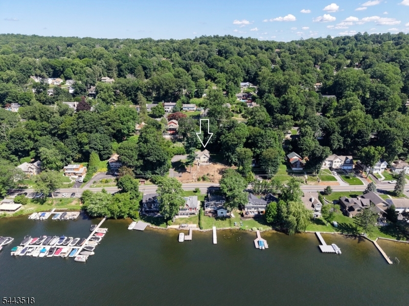 Lake life never looked better. Perfectly positioned across from Lake Mohawk and just steps from Beach #4, this beautifully updated retreat pairs timeless character with today's modern comforts. Original woodwork, exposed stone, and a classic fireplace with a redesigned floor plan, updated electrical and plumbing, high-efficiency three-zone heating, newer roof, upgraded insulation, interior Roth oil tank, and a town-verified 3-bedroom septic. A flexible bonus room is ideal for a home office, studio, or guest space. Outside, the rare double lot offers a fenced yard, multiple entertaining areas, stunning stonework, and room to expand. End your evenings by the fire pit with beautiful lake sunsets, then enjoy boating, paddle-boarding, hiking and skiing.