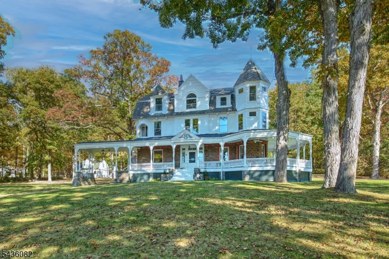 Stunning, beautifully renovated circa 1888 Queen Anne Victorian-replete with welcoming 1,670 sq. ft. wraparound front porch, asymmetrical exterior designs employing stone & patterned shingles, steeply pitched rooflines, round & polygon towers, original stained glass windows, & volume ceilings, plus original custom millworker, period doors & hardware, & hardwood flooring throughout--captures the charm & elegance of a bygone era but with all of today/s modern features & conveniences.  This  majestic home encompasses 4,742 sq. ft. of commodious living space on 3 flowing floors and boasts 14 rooms including 6 airy bedrooms, 3 renovated full baths, updated powder room, with two lovely primary bedroom suite options on separate floors- each with delightful sitting areas and en suite full baths: tasteful living room,  open floor plan family room features a sliding glass door to the inviting bluestone patio: renovated designer kitchen boast granite countertops w stainless steel farm sink, custom cabinetry, premium stainless steel appliances including a Thermador six burner gas range with center griddle & 2 ovens,  elegant dining room measures 27x14. The second & third floors offer high ceilings 6 bedrooms, 3 full baths, laundry room, home office and exercise room. Fully fenced 4.2 acre pancake flat property w restored 2-story barn, newer 6 bedroom septic system, public water, gas heat from newer boiler, brand new 2-zone central air conditioning (2nd & 3rd floors), plus Verizon Fios.