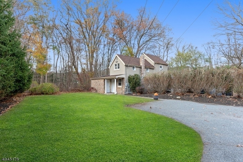 Warm and welcoming  2-bedroom, 1.5-bath Colonial farmhouse on over an acre of lush level land complete with 2-stall barn, riding arena, chicken coop, and waterfall feature. Set back from the road w/ spacious drive & oversized detached 2-car garage feat. workroom, all surrounded by 1,500 acres of woods with well-groomed riding trails. Main foyer opens to large living room feat. cozy woodstove, recessed lighting, & sliding-glass doors to fabulous screened-in porch w/ vaulted ceiling & entry to relaxing patio w/ hot tub. Bright updated gourmet kitchen feat. vaulted ceiling, skylights, center island, granite counters, custom stone backsplash, custom cabinets, crown molding, SS appliances, open flow to dining room w/ patio sliders, perfect for entertaining! Conveniently located from parks, schools, & worship.