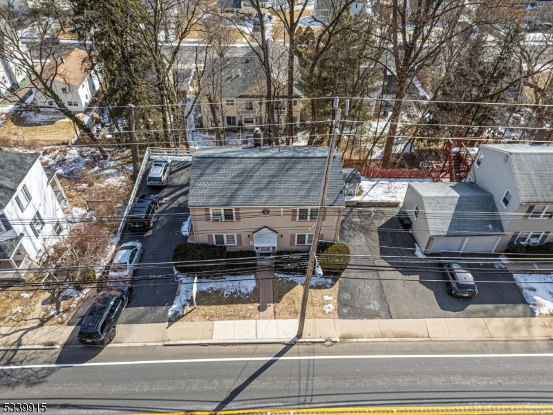 A remarkable multi-family home with TONS of opportunity, this property offers a unique opportunity for both investors, business owners & owner-occupants alike. Top floor unit, tenant is planning to move out end of June 2025, 1st floor unit lease ends September 2025, commercial space is VACANT. The first floor and second units feature identical floor-plans. Cozy yet spacious layout, each unit consisting of 2 bedrooms, a full bathroom & a spacious living room and kitchen.   BOTH with private outdoor deck areas and a large paver patio. Additionally, this building includes a ground level OFFICE/commercial space with over 350 square feet, perfect for any small business including insurance, attorneys, physicians, dentists, chiropractors, therapists, the list goes on! With a waiting room area, office, bathroom, laundry and tons of storage.. This property has the potential to make you a lot of revenue. Three zone heat. Two zone central air. Tons of significant and important upgrades - Brand new roof, new retaining walls, water heaters & central air system. TONS of parking with two driveways in truly a prime location along with its versatile layout, convenient amenities, this multi-family home is a rare find in today's market. Its classic colonial exterior welcomes residents & guests, while the variance sign promotes your business on Rt 202. 1/8 of a mile from the Morristown Green.