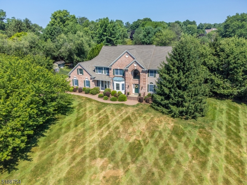 Country club living in the heart of Chester Twp!  A paver driveway and canopy of cherry trees welcome you to this fantastic, completely updated Colby Farms colonial.  Two story entry foyer, freshly painted formal dining room trimmed with moldings, front to back living room  features recessed lighting and custom blinds, family room with vaulted ceiling, skylights and gas fireplace open to completely updated and modern kitchen! Kitchen includes ceiling height cabinets, quartz countertop on huge center island, granite perimeter, vented range hood over Wolf 6 burner gas cooktop, Sub-Zero refrigerator/freezer, Wolf double wall ovens, Bosch dishwasher, wine refrigerator, ice maker and recessed lighting.  Laundry room with granite countertop and guest powder room complete the first floor. 2nd staircase leads to bonus room with 2 walk-in closets.  Second floor offers spacious primary suite with tray ceiling, recessed lighting two walk-in closets and luxurious new marble bath with soaking tub, double vanity, built-in speakers, electronic shower and heated floors.  Three additional large bedrooms and fully updated main bath with double vanity and tub shower complete the 2nd floor.  Finished basement  has recroom and unfinished storage areas, as well as a full bath with stall shower.  Outdoor living is paradise with patio and pergola, outdoor kitchen, Gunite pool w/spa and fire pit and storage shed surrounded by level and usable yard.  2 new furnaces and AC units, generator hookup +++